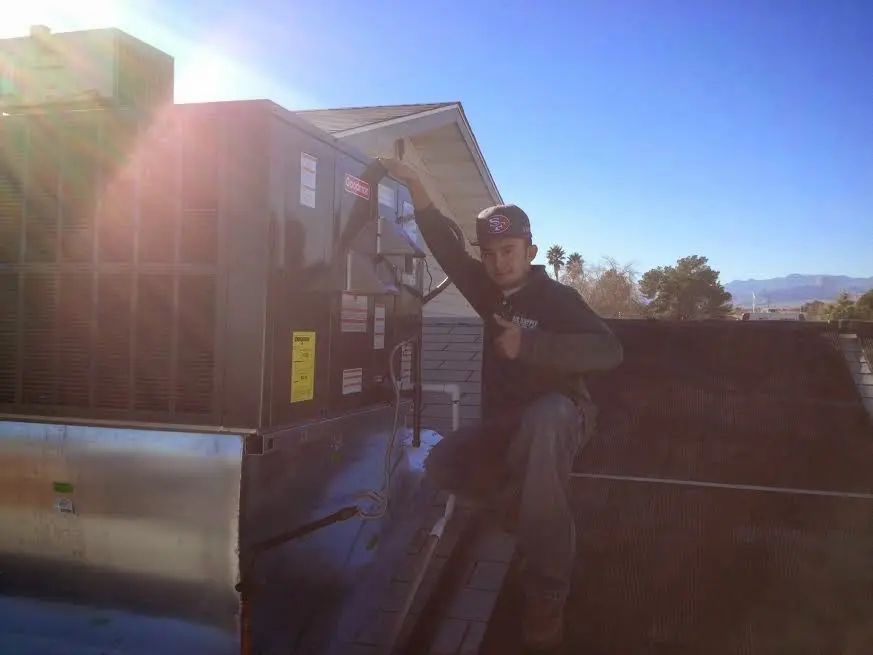 HVAC technician performing Boiler Repair on a rooftop unit in North Bethesda